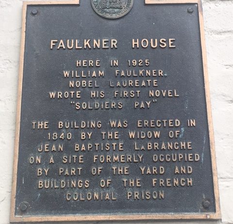 The plaque on the outside the building of Faulkner House, 624 Pirate's Alley, New Orleans.