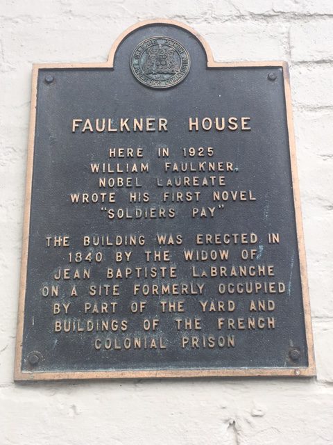 The plaque on the outside the building of Faulkner House, 624 Pirate's Alley, New Orleans.